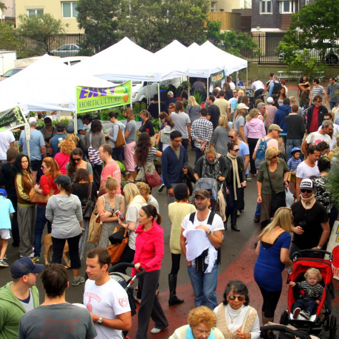 Bondi Markets held every Sunday — crowds browsing stalls with white marquees in an outdoor market
