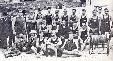 Bondi Surf Life Saving Club members group photo, December 1906, showing the newly modified reel and cork-filled vest