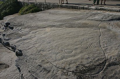 MacKenzies Point rock engraving showing a large whale, small fish, and examples of Bondi Points